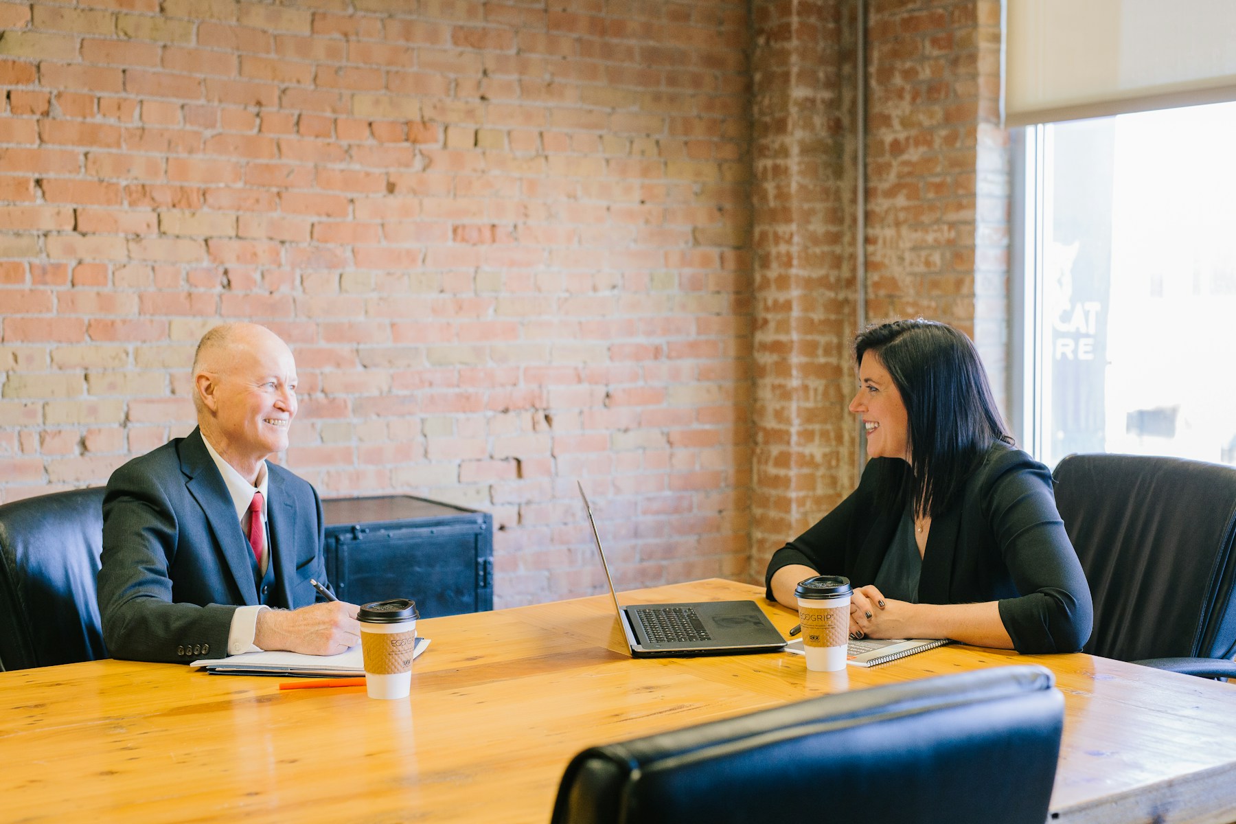 ALT: Photo of a support team working at a shared desk